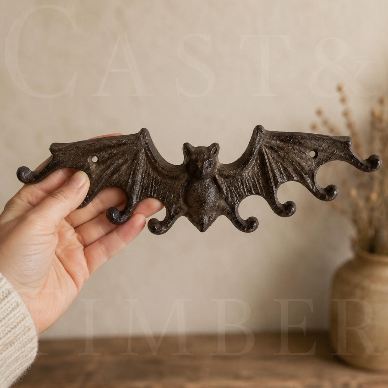 Cast iron bat wall hook rack shown for scale